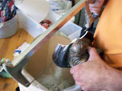 Carefully cutting off the broken base of the lamp
